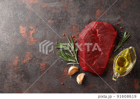 Concept of cooking with raw steak on textured background Concept of cooking with raw steak on textured background 91608619
