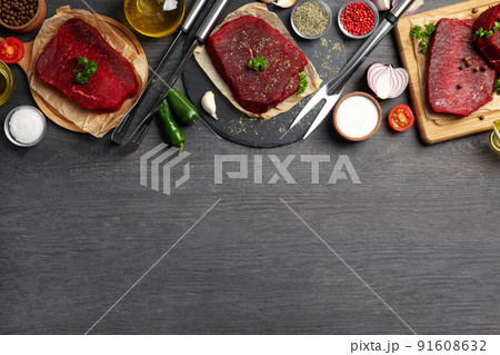 Concept of cooking with raw steak on wooden background 91608632
