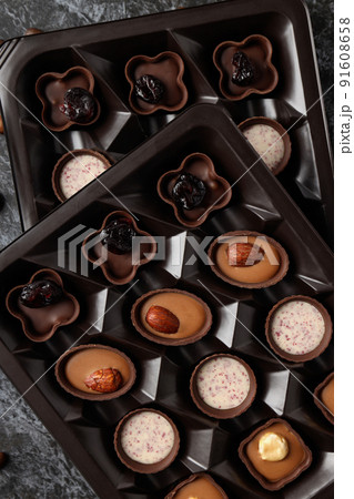 Chocolate candies in box all over background, close up Chocolate candies in box all over background, close up 91608658