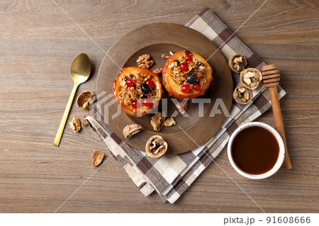 Concept of tasty food with baked apples on wooden background Concept of tasty food with baked apples on wooden background 91608666