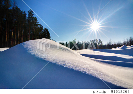 Wonderful winter landscape. Beautiful morning landscape of small snowy hills in winter. Frosty sunny morning. The beauty of winter and the warmth of the sun. Wonderful winter landscape. Beautiful morning landscape of small snowy hills in winter. Frosty sunny morning. The beauty of winter and the warmth of the sun. 91612262