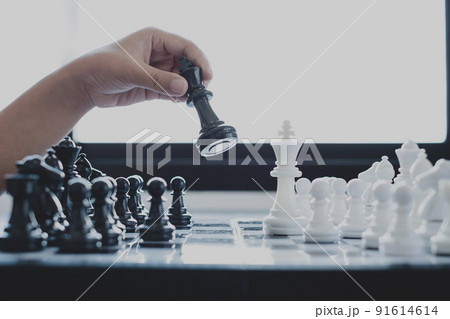 Hand of businesswoman moving, chess in competition shows leadership, followers, and business success strategies Hand of businesswoman moving, chess in competition shows leadership, followers, and business success strategies 91614614
