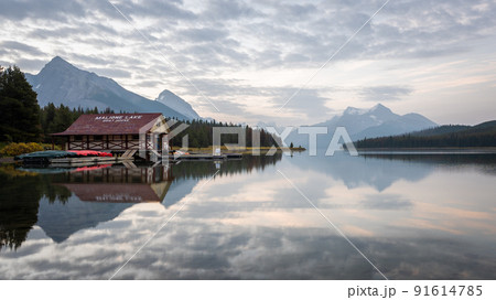 Peaceful sunrise on the bank of still alpine lake with boathouse, Jasper NP, Canada Peaceful sunrise on the bank of still alpine lake with boathouse, Jasper NP, Canada 91614785