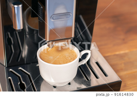 Espresso pouring from coffee machine, close up, professional coffee brewing. Espresso pouring from coffee machine, close up, professional coffee brewing. 91614830