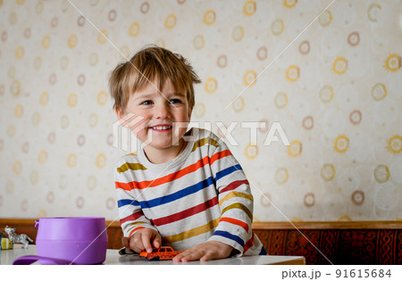 Happy smiling little child little boy with fork ready to eat healthy lunch. Kid portrait. Positive face of two years old boy in kindergarten 91615684