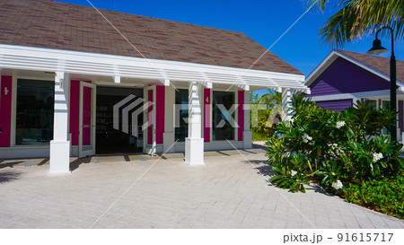 Beach on Ocean Cay Bahamas Island with a colorful houses and turquoise water 91615717