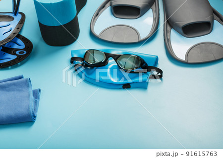 Sports equipment for swimming in the pool and open water on a blue background 91615763