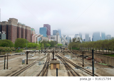 CHICAGO, ILLINOIS, UNITED STATES - MAY 12, 2018: Tracks with switches and trains in downtown Chicago's Grant Park with the skyline in the background CHICAGO, ILLINOIS, UNITED STATES - MAY 12, 2018: Tracks with switches and trains in downtown Chicago's Grant Park with the skyline in the background 91615794