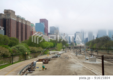 CHICAGO, ILLINOIS, UNITED STATES - MAY 12, 2018: Tracks with switches and trains in downtown Chicago's Grant Park with the skyline in the background CHICAGO, ILLINOIS, UNITED STATES - MAY 12, 2018: Tracks with switches and trains in downtown Chicago's Grant Park with the skyline in the background 91615804