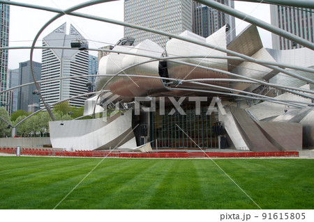 CHICAGO, ILLINOIS, UNITED STATES - MAY 12, 2018: Jay Pritzker Pavilion is the concert shell designed by architect Frank Gehry in Millennium Park on a sunny spring day CHICAGO, ILLINOIS, UNITED STATES - MAY 12, 2018: Jay Pritzker Pavilion is the concert shell designed by architect Frank Gehry in Millennium Park on a sunny spring day 91615805