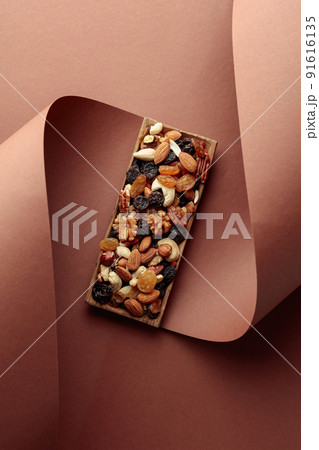 The mix of dried fruits and berries on a brown background. 91616135