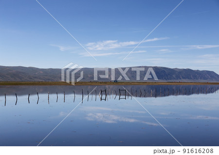 Flooded Farmland and Fence surrounded by Mountains. Flooded Farmland and Fence surrounded by Mountains. 91616208