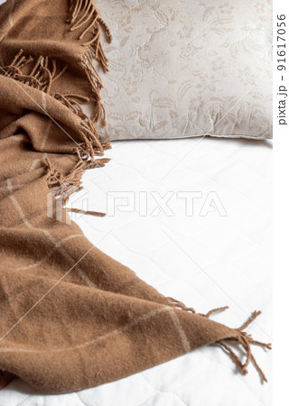 Unmade messy bedroom in the morning with pillow and plaid on bed Unmade messy bedroom in the morning with pillow and plaid on bed 91617056