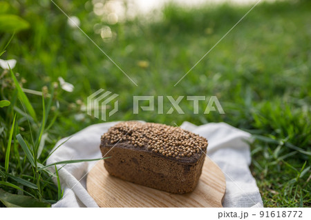 Composition of homemade custard bread on wood board with white cloth napkin on the green grass. High quality photo 91618772
