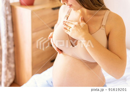 Breast examination cancer pregnant woman check. Young pregnancy woman examining breast for signs lumps. Breast self exam BSE, breast cancer awareness concept. Breast examination cancer pregnant woman check. Young pregnancy woman examining breast for signs lumps. Breast self exam BSE, breast cancer awareness concept. 91619201