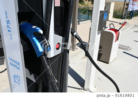 France, highway to Paris, June 2022. At a motorway rest area, close-up shot on the fast charging column. In evidence the blue charging socket. France, highway to Paris, June 2022. At a motorway rest area, close-up shot on the fast charging column. In evidence the blue charging socket. 91619801