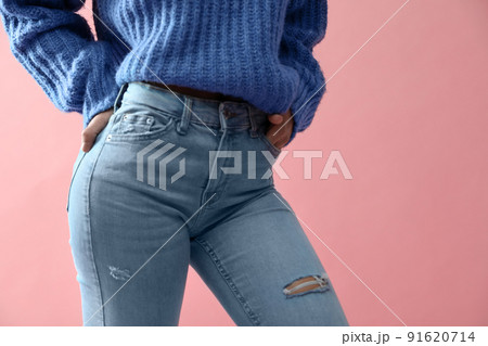 Woman wearing jeans on pink background, closeup 91620714