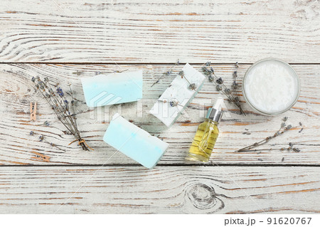 Flat lay composition with natural handmade soap and ingredients on white wooden table 91620767