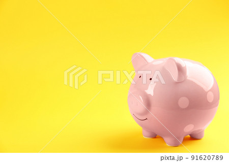 Pink piggy bank on yellow background. Space for text Pink piggy bank on yellow background. Space for text 91620789