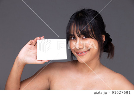 Asian Indian woman show beautiful smile happy lips, hold empty blank package box for treatment skin Asian Indian woman show beautiful smile happy lips, hold empty blank package box for treatment skin 91627691