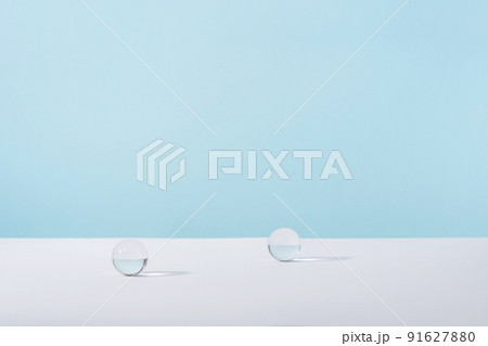 Acrylic glass spheres on blue background for cosmetic or perfume showcase. Creative geometric product stage mock up, cosmetics display wall, product advertising desk, geometric stand 91627880