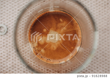 Close up top view of espresso coffee with nice crema in small glass. Close up top view of espresso coffee with nice crema in small glass. 91628988
