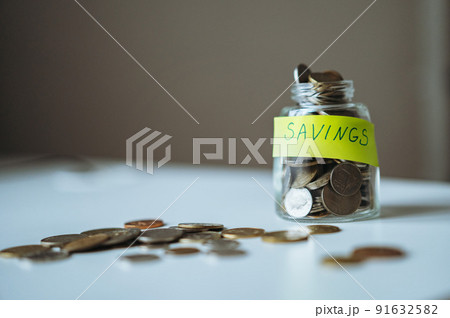 saving money concept. glass jar full of coins. Image with selective focus 91632582