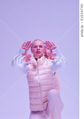 Woman with little girl in futuristic costume wearing smart led glasses of virtual reality while touching air. Augmented reality game, future technology, AI concept. VR. Neon light. Woman with little girl in futuristic costume wearing smart led glasses of virtual reality while touching air. Augmented reality game, future technology, AI concept. VR. Neon light. 91634740