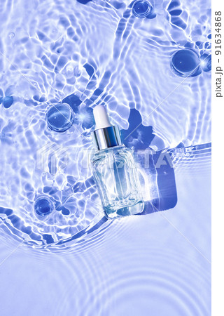 Mockup of cosmetic glass purple bottle with pipette and serum on water surface with waves 91634868
