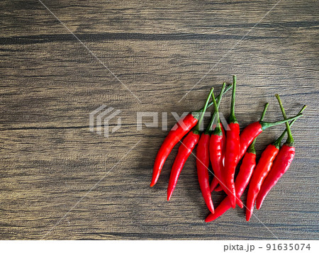 Fresh red chili and space for text on wooden background Fresh red chili and space for text on wooden background 91635074