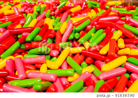 Abstract multicolored background made of many colorful sweet sticks of chewing sweets in icing. A tasty and healthy delicacy made from gelled fruit juice. Abstract multicolored background made of many colorful sweet sticks of chewing sweets in icing. A tasty and healthy delicacy made from gelled fruit juice. 91636590