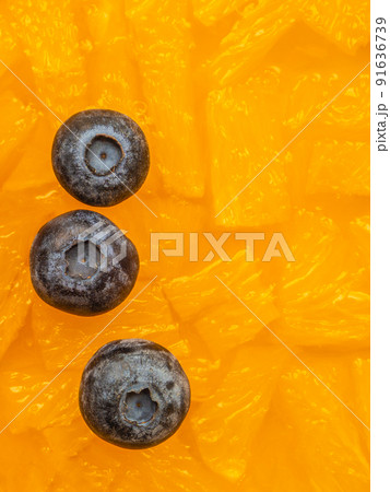 Flatlay. Top view of blueberries on orange jelly. Flatlay. Top view of blueberries on orange jelly. 91636739