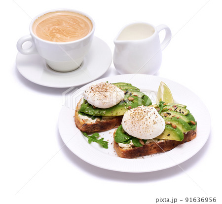 Freshly made poached egg and Avocado toasts isolated on white background Freshly made poached egg and Avocado toasts isolated on white background 91636956