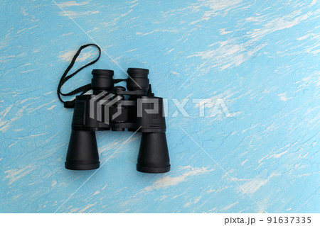 Travel, summer vacation, tourism and objects concept - close up binoculars. Top view with copy space. Travel, summer vacation, tourism and objects concept - close up binoculars. Top view with copy space. 91637335