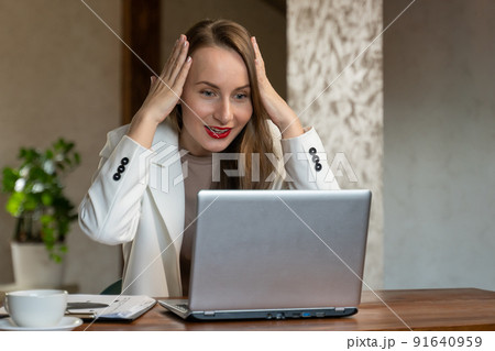 Happy excited successful business woman triumphing with laptop Happy excited successful business woman triumphing with laptop 91640959