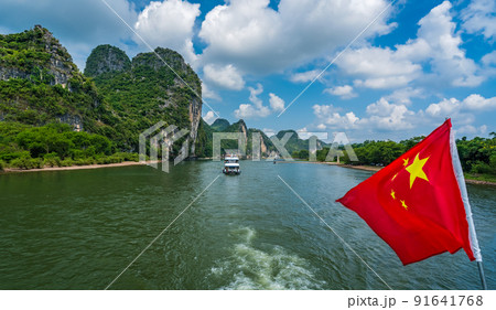 Red Chinese national flag on a boat sailing on Li River 91641768