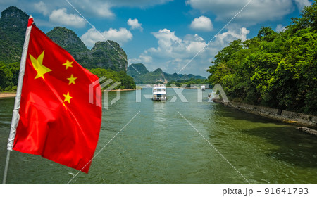Red Chinese national flag on a boat sailing on Li River 91641793