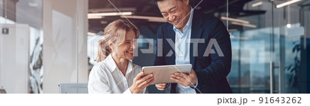 Business people in office meeting for project and discuss it using laptop and tablet Business people in office meeting for project and discuss it using laptop and tablet 91643262