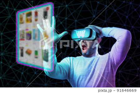 Collage of virtual reality. Portrait of shocked man in VR glasses choice food at internet shop, point at digital screen. Dark background. The concept of metaverse and online shopping Collage of virtual reality. Portrait of shocked man in VR glasses choice food at internet shop, point at digital screen. Dark background. The concept of metaverse and online shopping 91646669