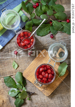 Homemade dogwood jam on a wooden background. Organic jam, healthy food. View from above. Homemade dogwood jam on a wooden background. Organic jam, healthy food. View from above. 91647387
