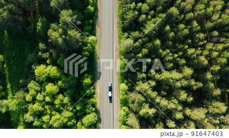 car with trailer moving on road in summer forest, drone dolly shot car with trailer moving on road in summer forest, drone dolly shot 91647403