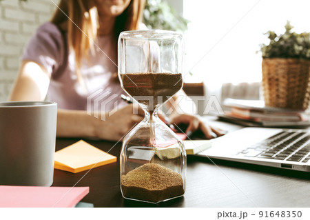 Close up of a woman writing something on the paper in office 91648350