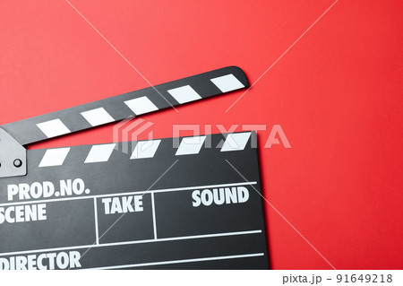 Clapper board on red background, top view. Cinema production 91649218