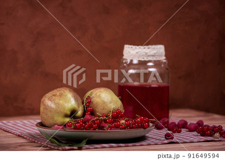 Compote, red currants, raspberries and apples on an old wooden table. Compote, red currants, raspberries and apples on an old wooden table. 91649594