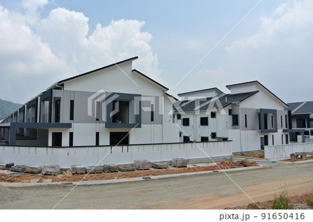 SELANGOR, MALAYSIA -MAY 2, 2022: Selected focused on new double story terrace house under construction in Malaysia. Construction progress is almost complete and almost ready to be occupied. 91650416