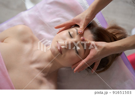 Woman lay on couch on her back with her eyes closed and enjoy. Makes relaxing Woman lay on couch on her back with her eyes closed and enjoy. Makes relaxing 91651503