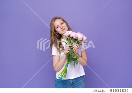 Beautiful young lady with spring flowers celebrating Women's Day, advertising Beautiful young lady with spring flowers celebrating Women's Day, advertising 91651835