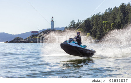 Adventurous Caucasian Woman on Sea-Doo riding in the Ocean 91651837