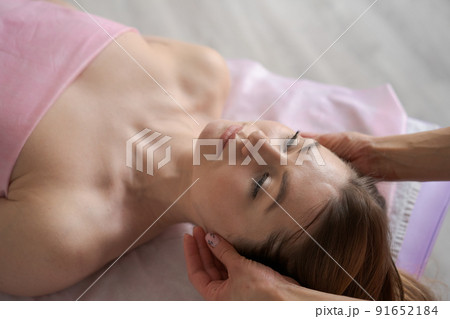 Woman lay on couch on her back with her eyes closed and enjoy. Makes relaxing 91652184
