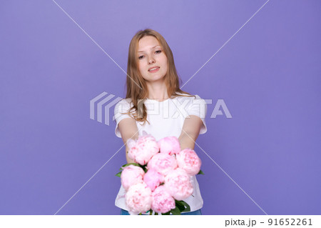 Beautiful young lady with spring flowers celebrating Women's Day, advertising 91652261